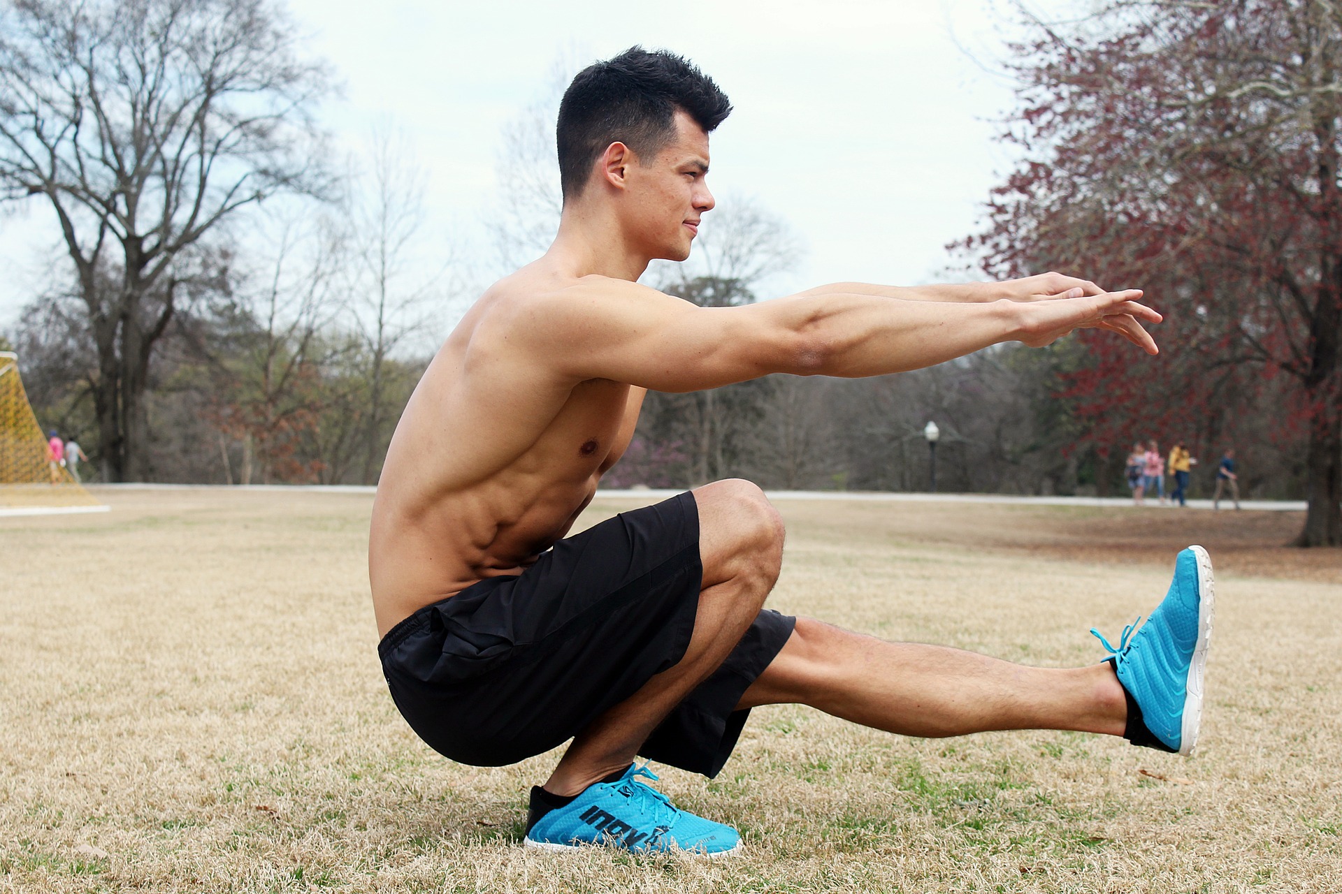 man doing bodyweight squats at home during a lower body workout